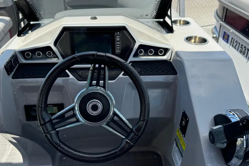 Slide: The Image of Steering console of 2022 Manitou Oasis SR VP boat with modern controls and display. - 12