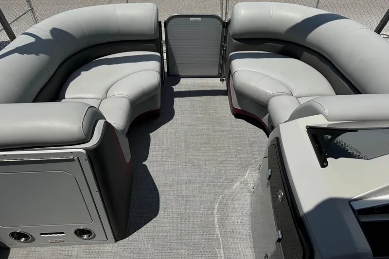 Slide: The Image of 2022 Manitou Oasis SR VP pontoon boat interior with gray seating and carpeted floor. - 13
