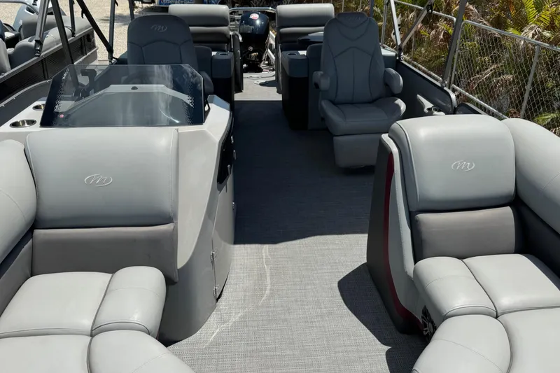 Slide: The Image of 2022 Manitou Oasis SR VP pontoon boat with luxurious gray seating and spacious interior layout. - 17