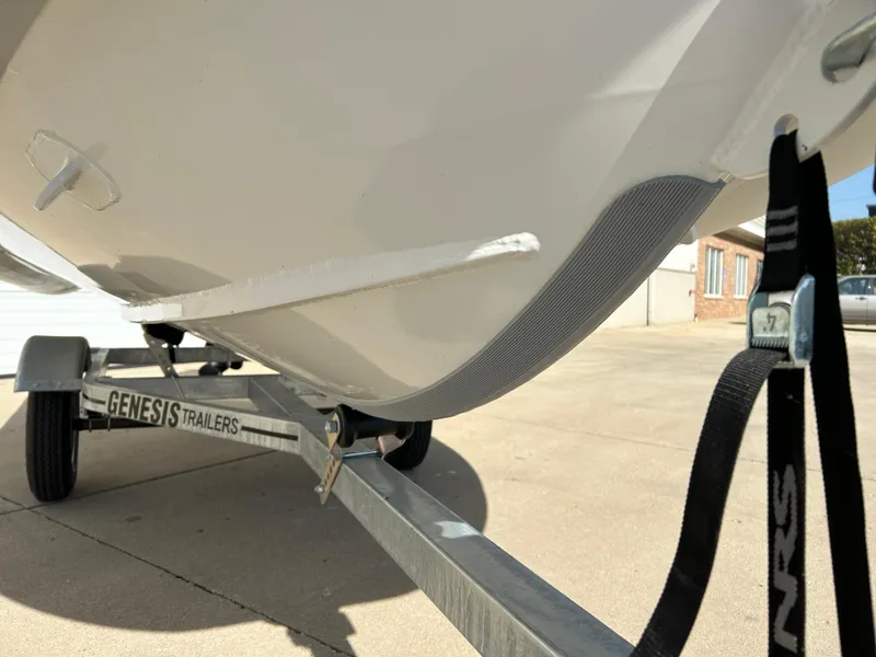 Slide: The Image of 2024 Highfield Classic 420 boat on Genesis trailer, close-up view of hull and strap. - 11