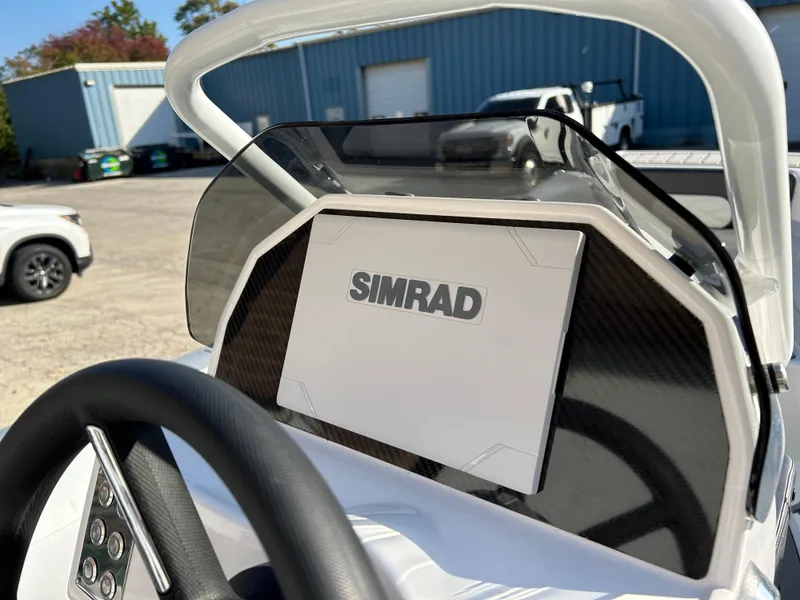 Slide: The Image of 2024 Highfield Classic 420 boat dashboard with Simrad navigation system. - 5