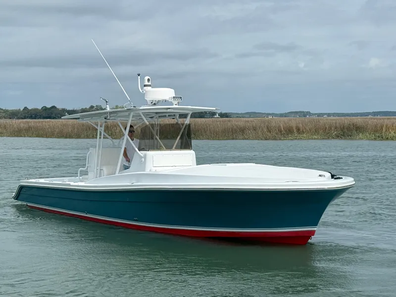 Slide: The Image of 2003 Strike 35 Cuddy boat on calm water, featuring a sleek design and vibrant colors. - 0