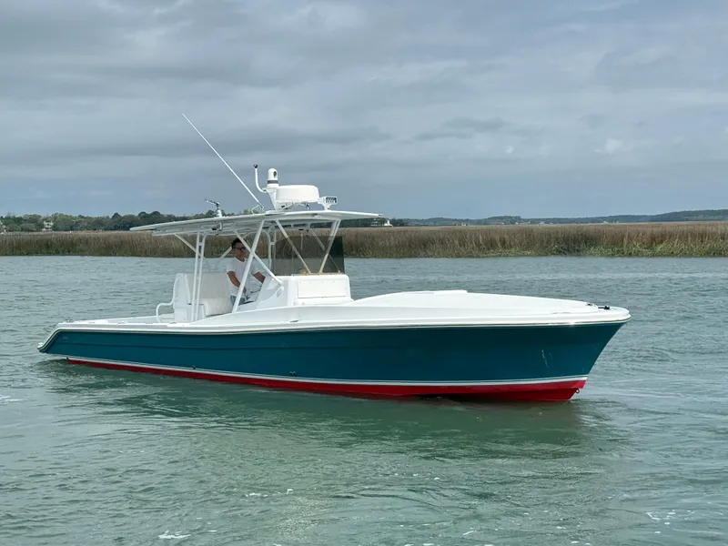 Slide: The Image of 2003 Strike 35 Cuddy boat on calm water, featuring a sleek design and vibrant colors. - 1