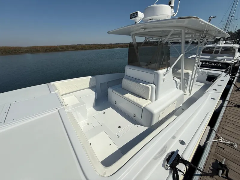 Slide: The Image of 2003 Strike 35 Cuddy boat docked, featuring spacious seating and sleek design. - 10