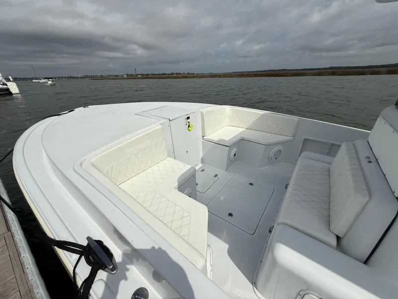 Slide: The Image of 2003 Strike 35 Cuddy boat with white seating, docked on a cloudy day. - 11