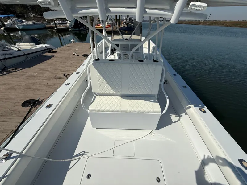 Slide: The Image of 2003 Strike 35 Cuddy boat with white seating, docked at a marina. - 13