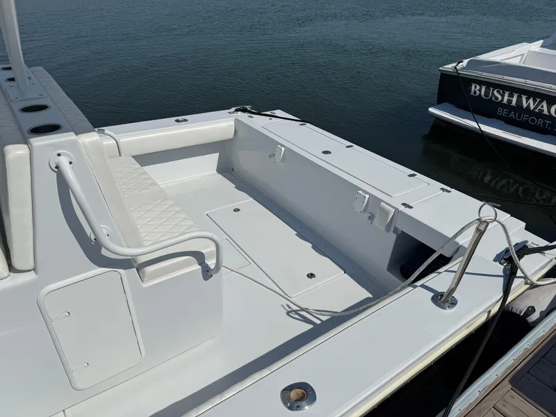 Slide: The Image of 2003 Strike 35 Cuddy boat with spacious deck, docked by the water. - 14