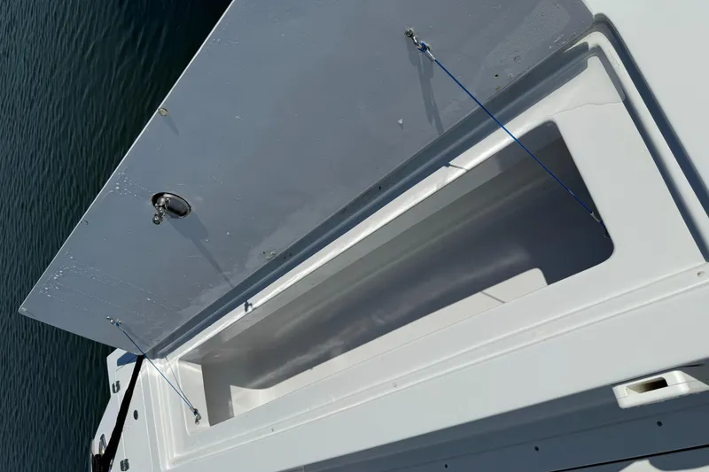Slide: The Image of Open storage compartment on a 2003 Strike 35 Cuddy boat. - 16