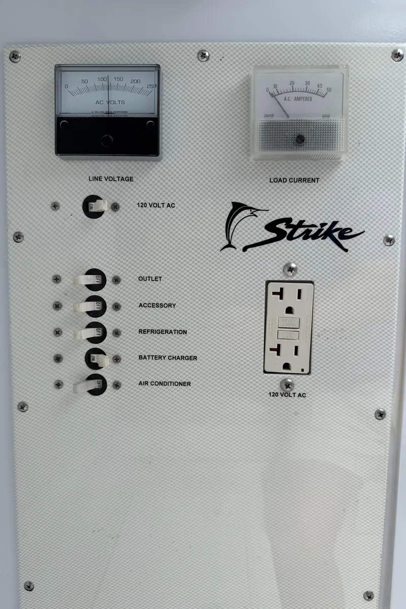 Slide: The Image of Electrical panel of 2003 Strike 35 Cuddy boat with voltmeter and outlet. - 20