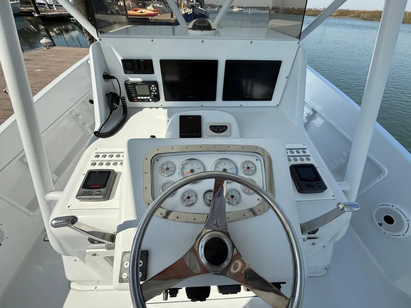 Slide: The Image of Helm of 2003 Strike 35 Cuddy boat with steering wheel and navigation instruments. - 21