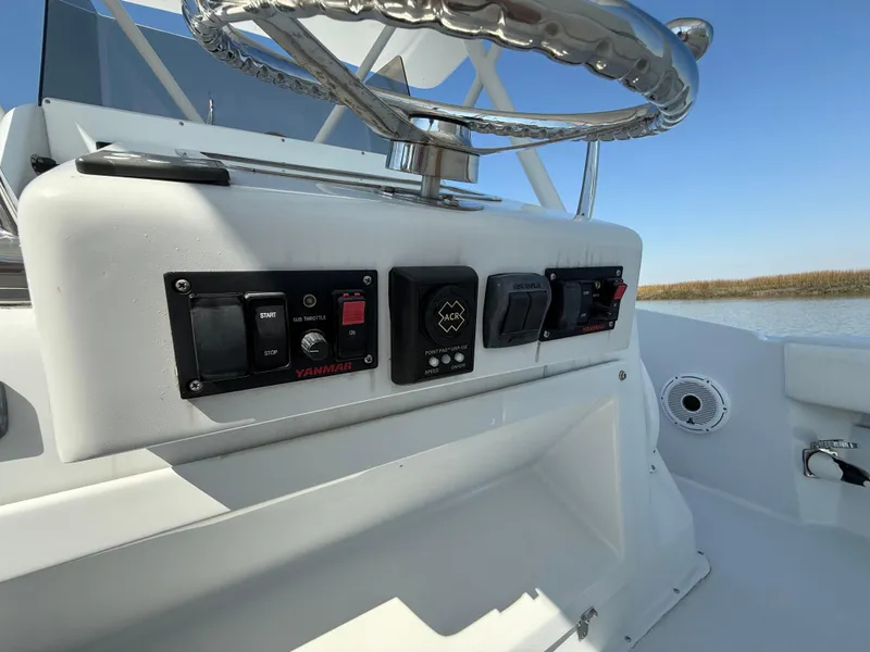 Slide: The Image of 2003 Strike 35 Cuddy boat dashboard with steering wheel and control panel. - 23