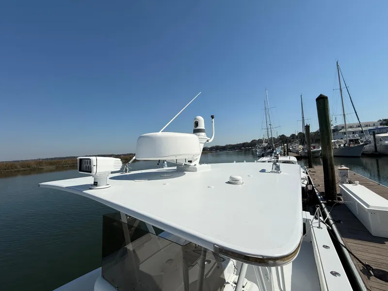 Slide: The Image of 2003 Strike 35 Cuddy boat docked, featuring radar and navigation equipment on the roof. - 24