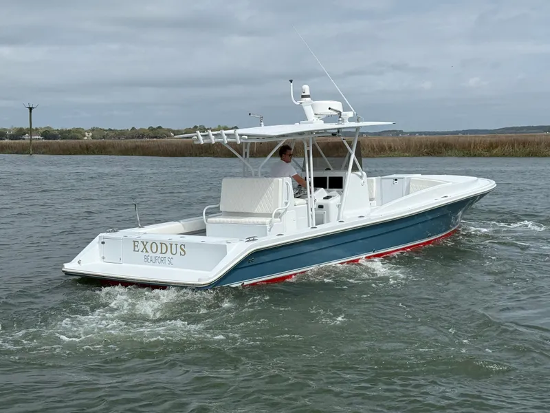 Slide: The Image of 2003 Strike 35 Cuddy boat cruising on water, featuring sleek design and white hull. - 3