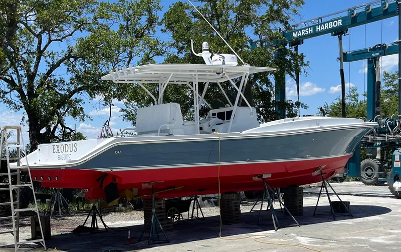 Slide: The Image of 2003 Strike 35 Cuddy boat on dry dock at Marsh Harbor, featuring a red and gray hull. - 5