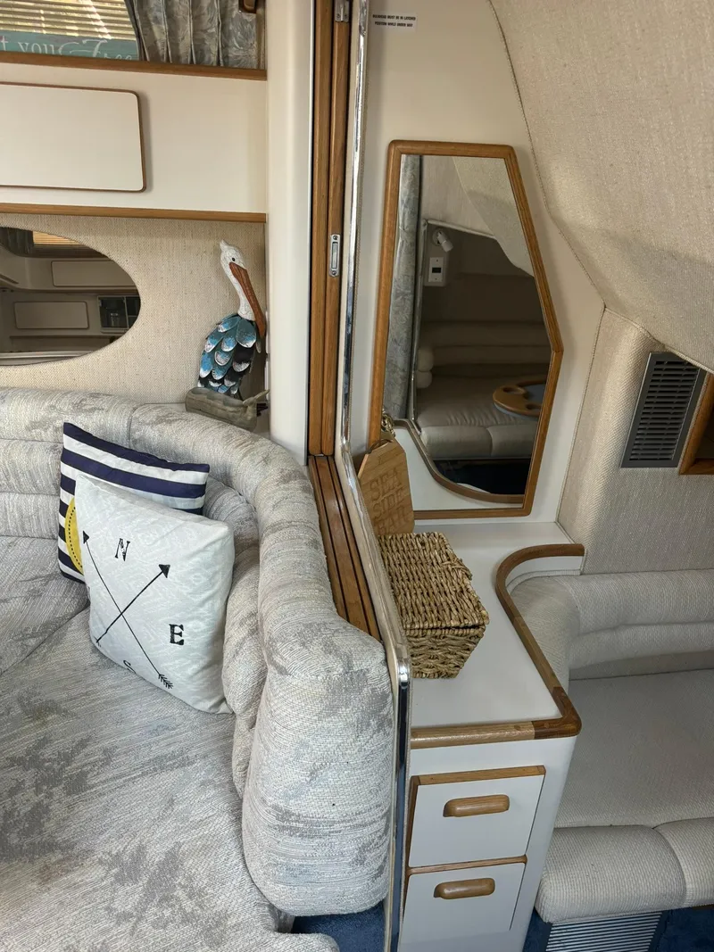 Slide: The Image of Interior of a 1993 Sea Ray 370 Sundancer with cozy seating and nautical decor. - 15