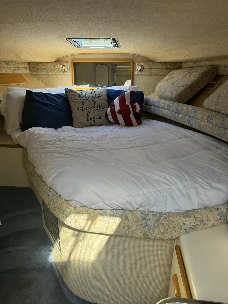 Slide: The Image of Cozy cabin interior of 1993 Sea Ray 370 Sundancer with plush bedding and decorative pillows. - 4