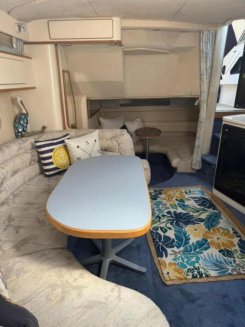 Slide: The Image of Interior of 1993 Sea Ray 370 Sundancer with cozy seating and nautical decor. - 6