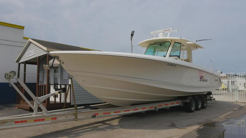 Slide: The Image of 2018 Boston Whaler 380 Outrage boat on trailer at marina. - 1