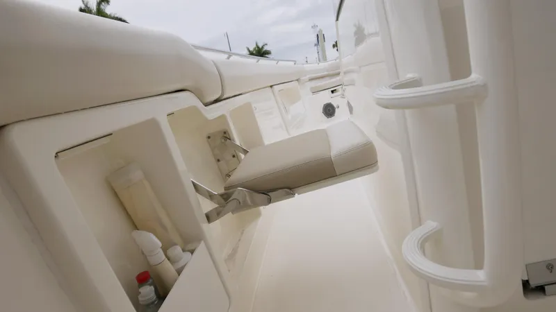 Slide: The Image of 2018 Boston Whaler 380 Outrage interior with storage compartments and seating. - 14