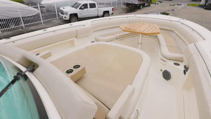 Slide: The Image of 2018 Boston Whaler 380 Outrage boat with spacious seating and table on deck. - 17