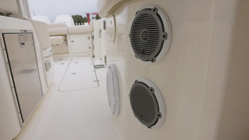 Slide: The Image of 2018 Boston Whaler 380 Outrage boat interior with speakers and seating area. - 18