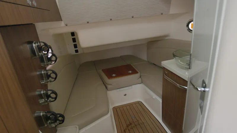 Slide: The Image of Interior cabin of 2018 Boston Whaler 380 Outrage, featuring seating and wooden accents. - 19