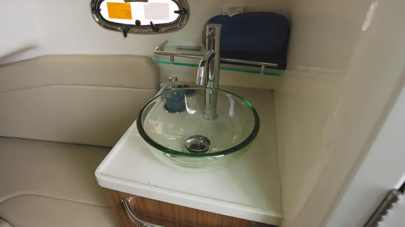 Slide: The Image of 2018 Boston Whaler 380 Outrage interior with modern glass sink and seating area. - 20