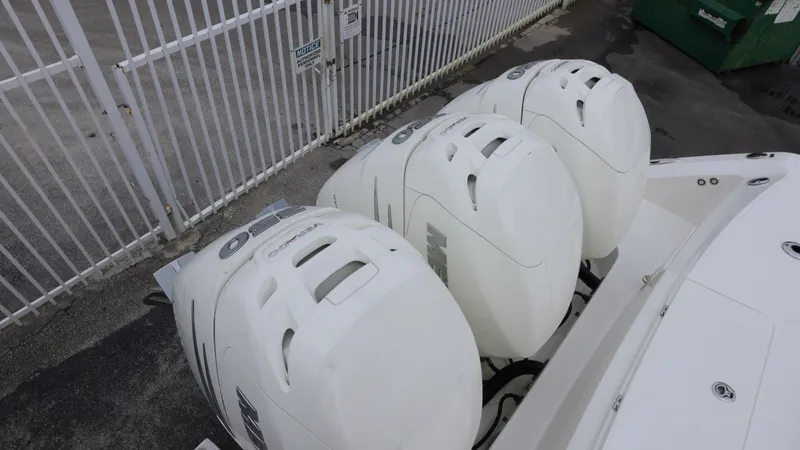 Slide: The Image of Three powerful outboard engines on a 2018 Boston Whaler 380 Outrage boat. - 21