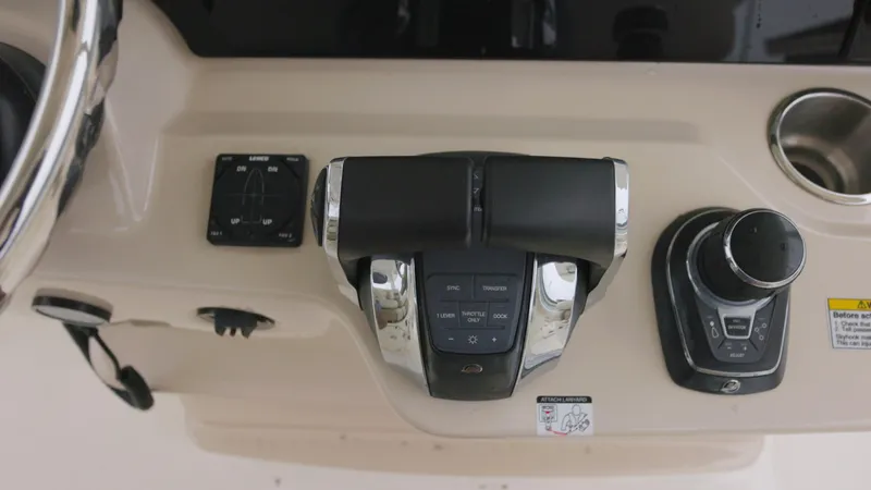 Slide: The Image of Control panel of a 2018 Boston Whaler 380 Outrage boat, featuring throttle and joystick. - 8