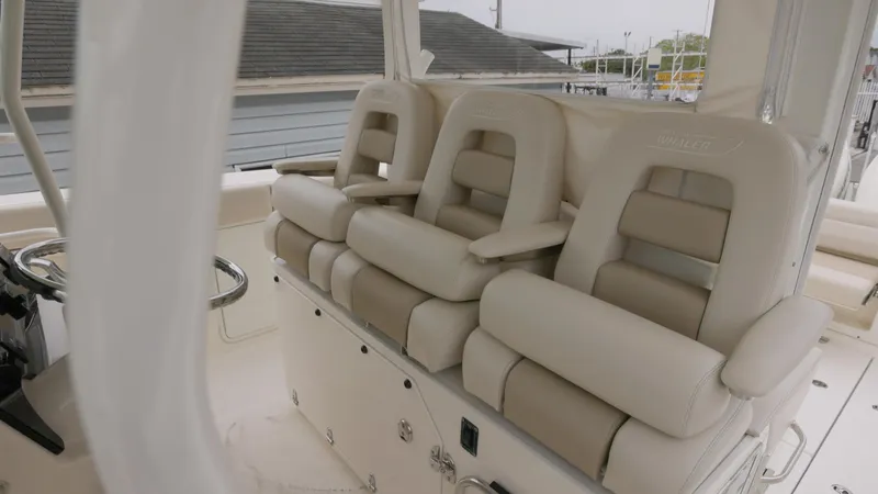 Slide: The Image of Luxury seating on 2018 Boston Whaler 380 Outrage boat, featuring plush, beige upholstery. - 9