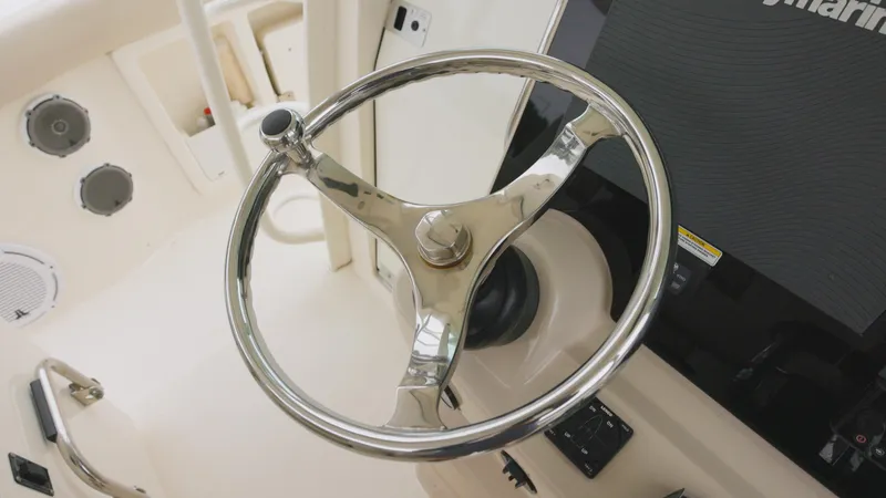 Slide: The Image of Steering wheel of a 2018 Boston Whaler 380 Outrage boat, featuring a sleek design. - 5