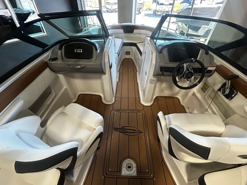 Slide: The Image of 2025 Chaparral 23 SSi boat interior with modern seating and sleek dashboard design. - 5