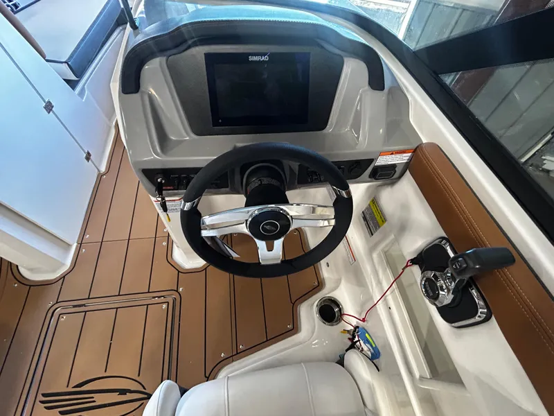 Slide: The Image of 2025 Chaparral 23 SSi boat cockpit with steering wheel and control panel. - 6