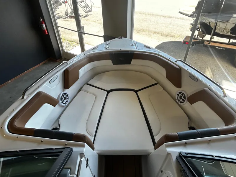 Slide: The Image of 2025 Chaparral 23 SSi boat interior with cushioned seating and speakers. - 7