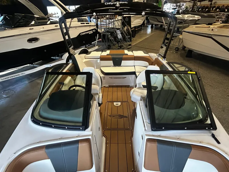 Slide: The Image of 2025 Chaparral 23 SSi boat interior with tan and white seating, in showroom. - 8