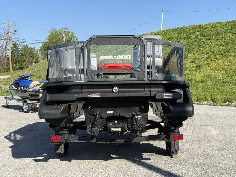 Slide: The Image of 2024 Sea-Doo SWITCH COMPACT 130HP on trailer, rear view, outdoors. - 13