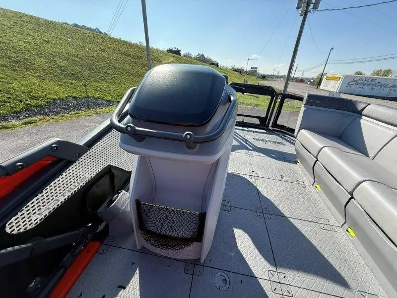 Slide: The Image of 2024 Sea-Doo SWITCH COMPACT 130HP interior with seating and helm, parked outdoors. - 18