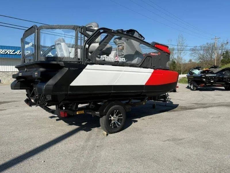 Slide: The Image of 2024 Sea-Doo SWITCH COMPACT 130HP on trailer, black and red design, parked outdoors. - 3