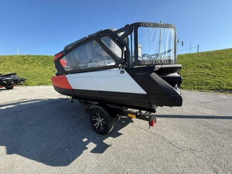 Slide: The Image of 2024 Sea-Doo SWITCH COMPACT 130HP on trailer, parked on pavement under clear blue sky. - 4