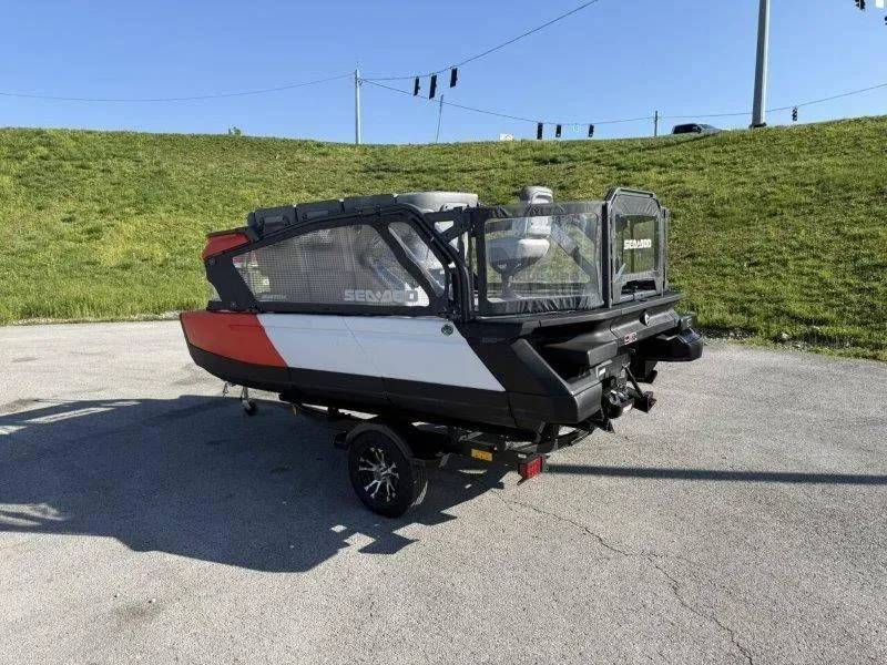 Slide: The Image of 2024 Sea-Doo SWITCH COMPACT 130HP on trailer, parked on asphalt with grassy background. - 6