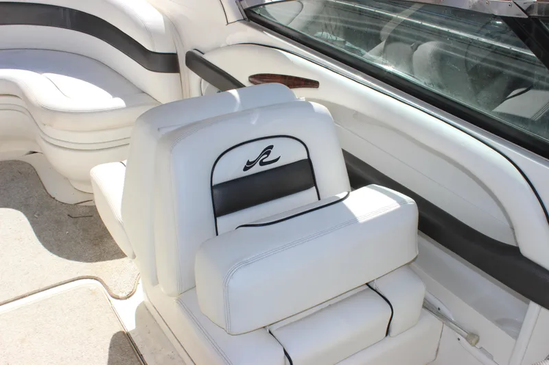 Slide: The Image of 2005 Sea Ray 290 Sundeck interior with white seating and sleek design. - 16
