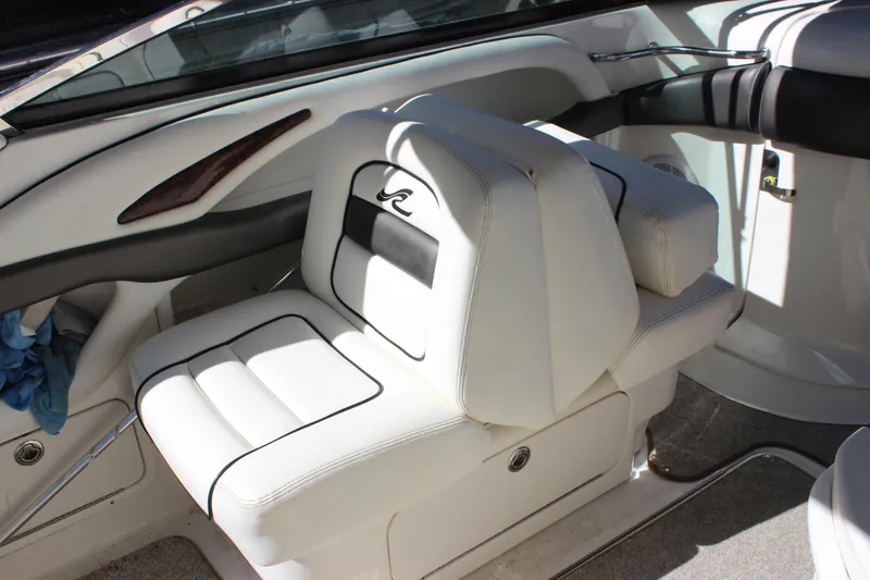 Slide: The Image of 2005 Sea Ray 290 Sundeck interior with white leather seating and sleek design. - 17