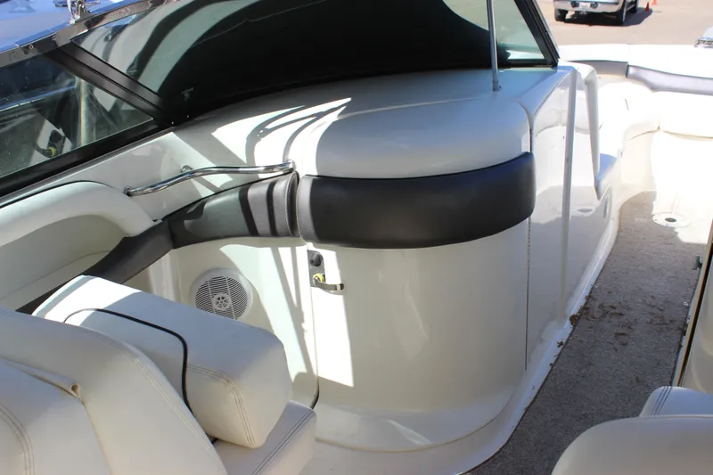 Slide: The Image of 2005 Sea Ray 290 Sundeck interior with white seating and sleek design. - 18