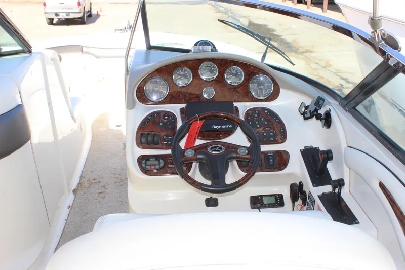 Slide: The Image of Cockpit of 2005 Sea Ray 290 Sundeck with steering wheel and instrument panel. - 19