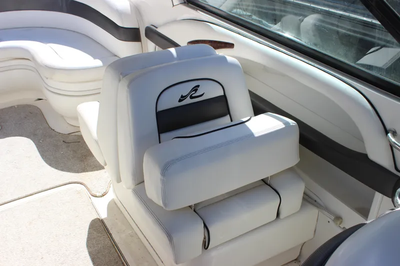 Slide: The Image of 2005 Sea Ray 290 Sundeck interior with white seating and elegant design. - 27