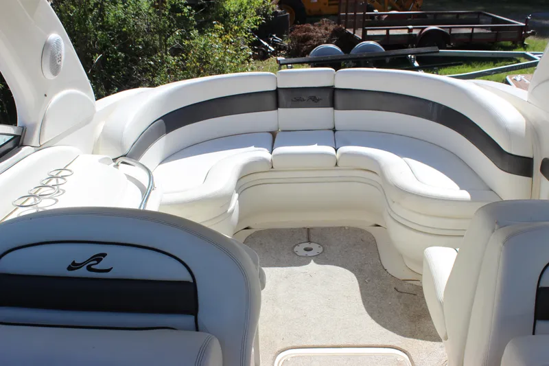 Slide: The Image of 2005 Sea Ray 290 Sundeck interior with white seating and elegant design. - 29