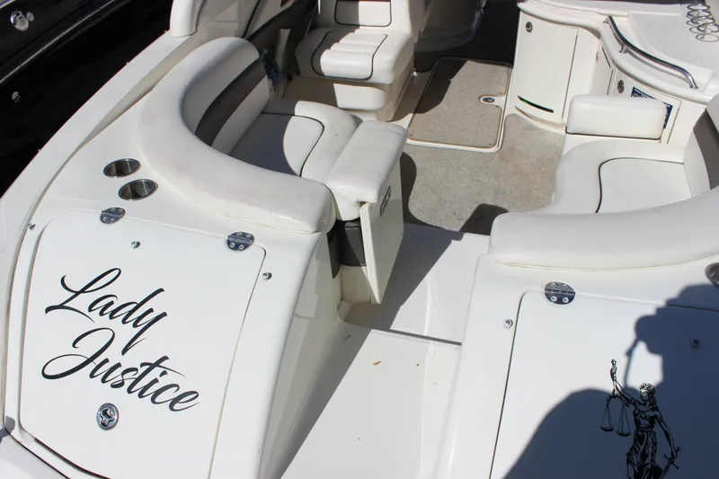Slide: The Image of 2005 Sea Ray 290 Sundeck interior with "Lady Justice" text, featuring white seating and deck. - 31