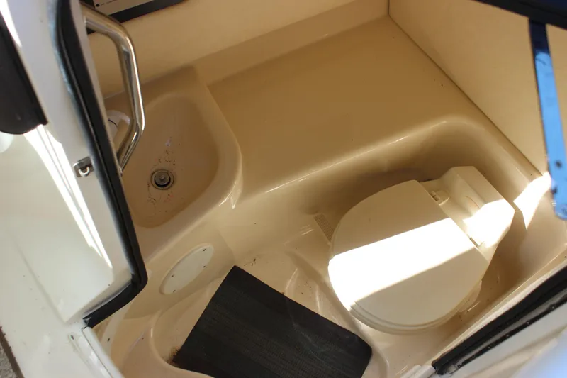Slide: The Image of 2005 Sea Ray 290 Sundeck boat bathroom interior with toilet and sink. - 32