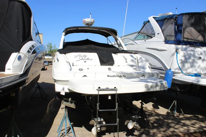 Slide: The Image of 2005 Sea Ray 290 Sundeck boat on stands, rear view, sunny day. - 4