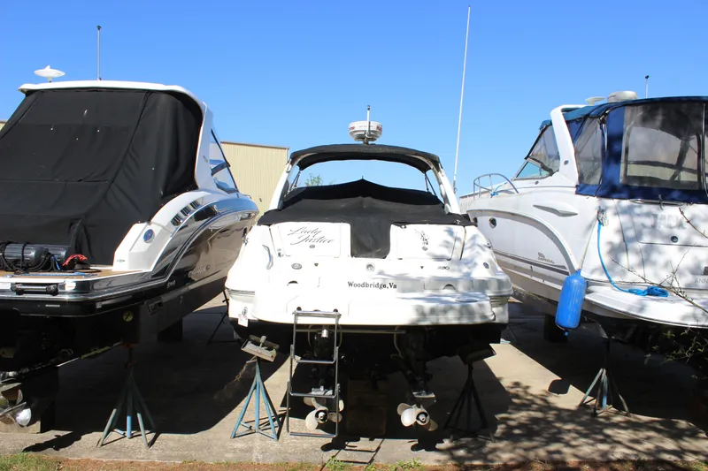 Slide: The Image of 2005 Sea Ray 290 Sundeck boat on stands, flanked by two other boats. - 5